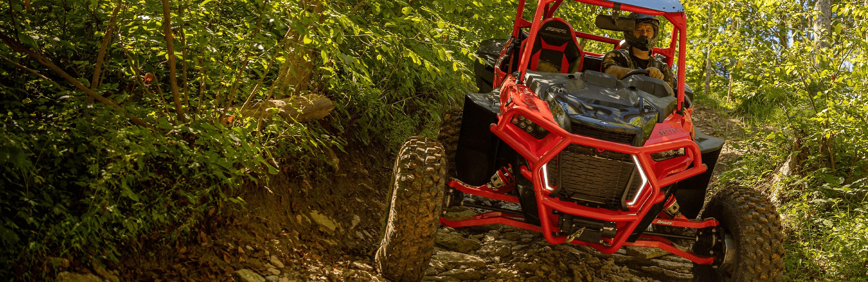 Red Honda Pioneer 1000 UTV using winch to get out of mud