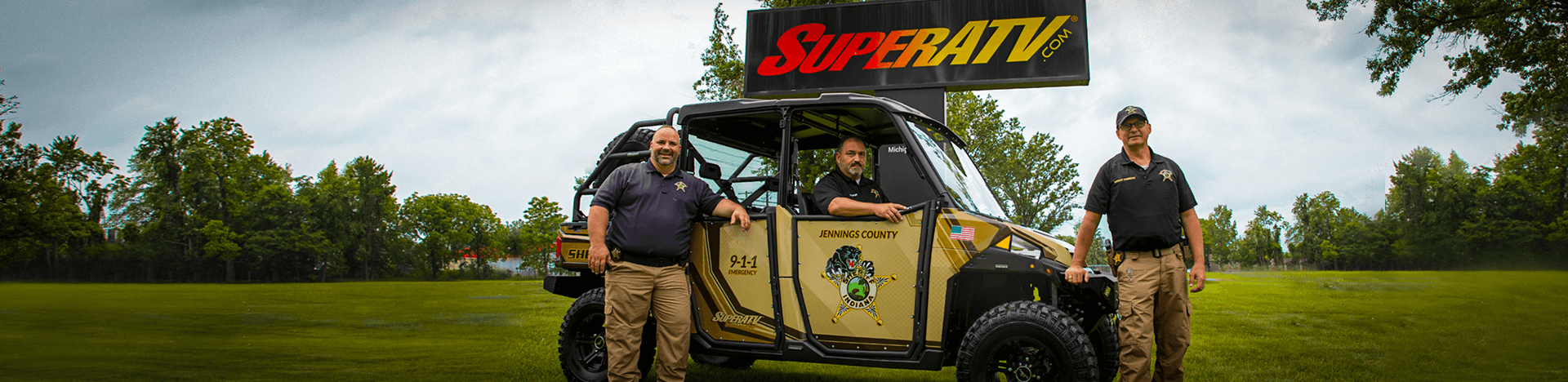 Image of three law enforcement offices in front of a tan and brown UTV customized by SuperATV