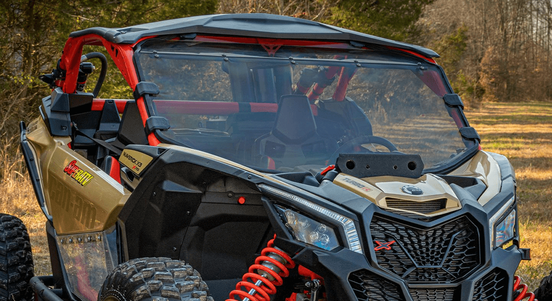 Image of a gold and black Can-Am Mav X3 UTV with a SuperATV full windshield installed.