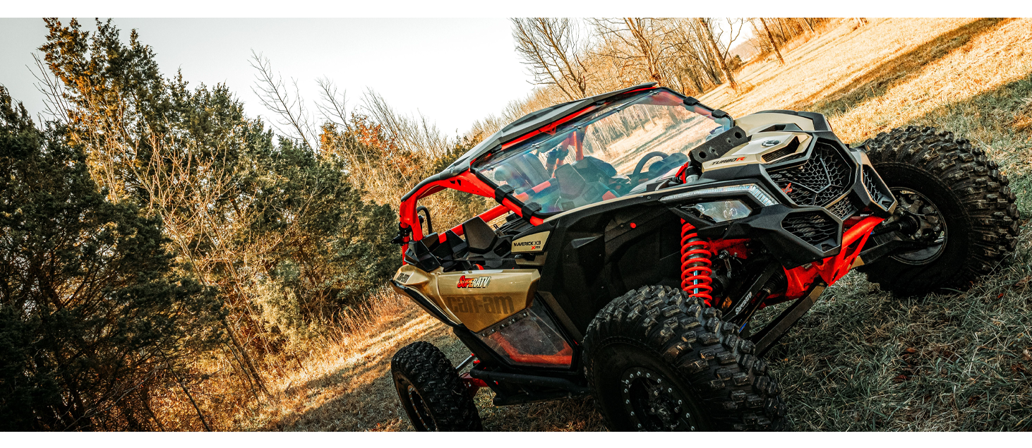 Image of a gold and black Can-Am Mav X3 UTV with a SuperATV full windshield installed.